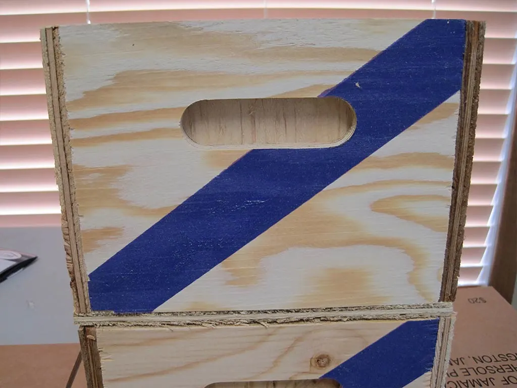 Close up of custom wooden boxes with a blue stripe over the handle. Built by 204 Pallet & Packaging in Winnipeg, Manitoba.