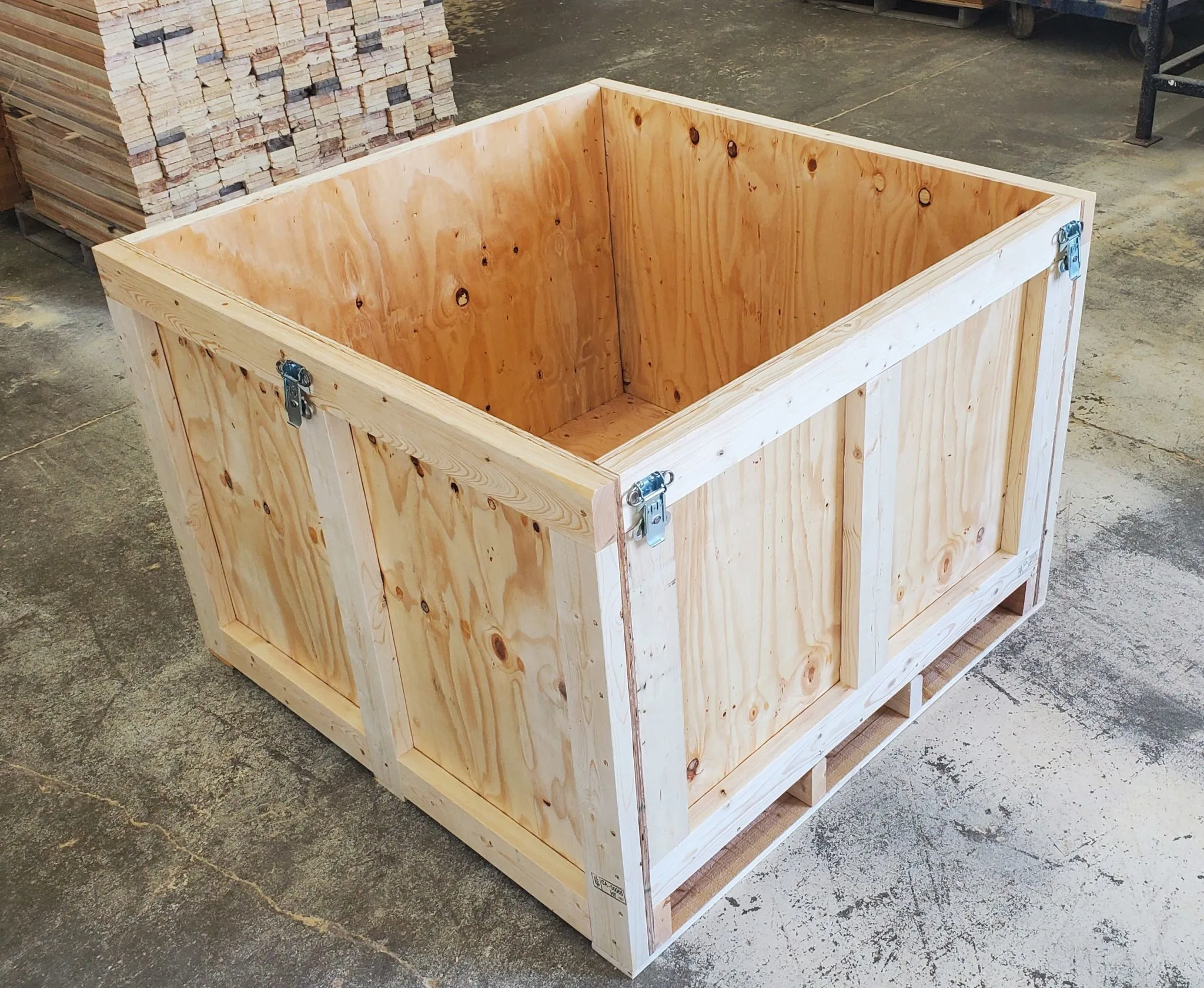 A custom wooden crate with the lid open and latches on the sides. Available at 204 Pallet & Packaging in Winnipeg, Manitoba.