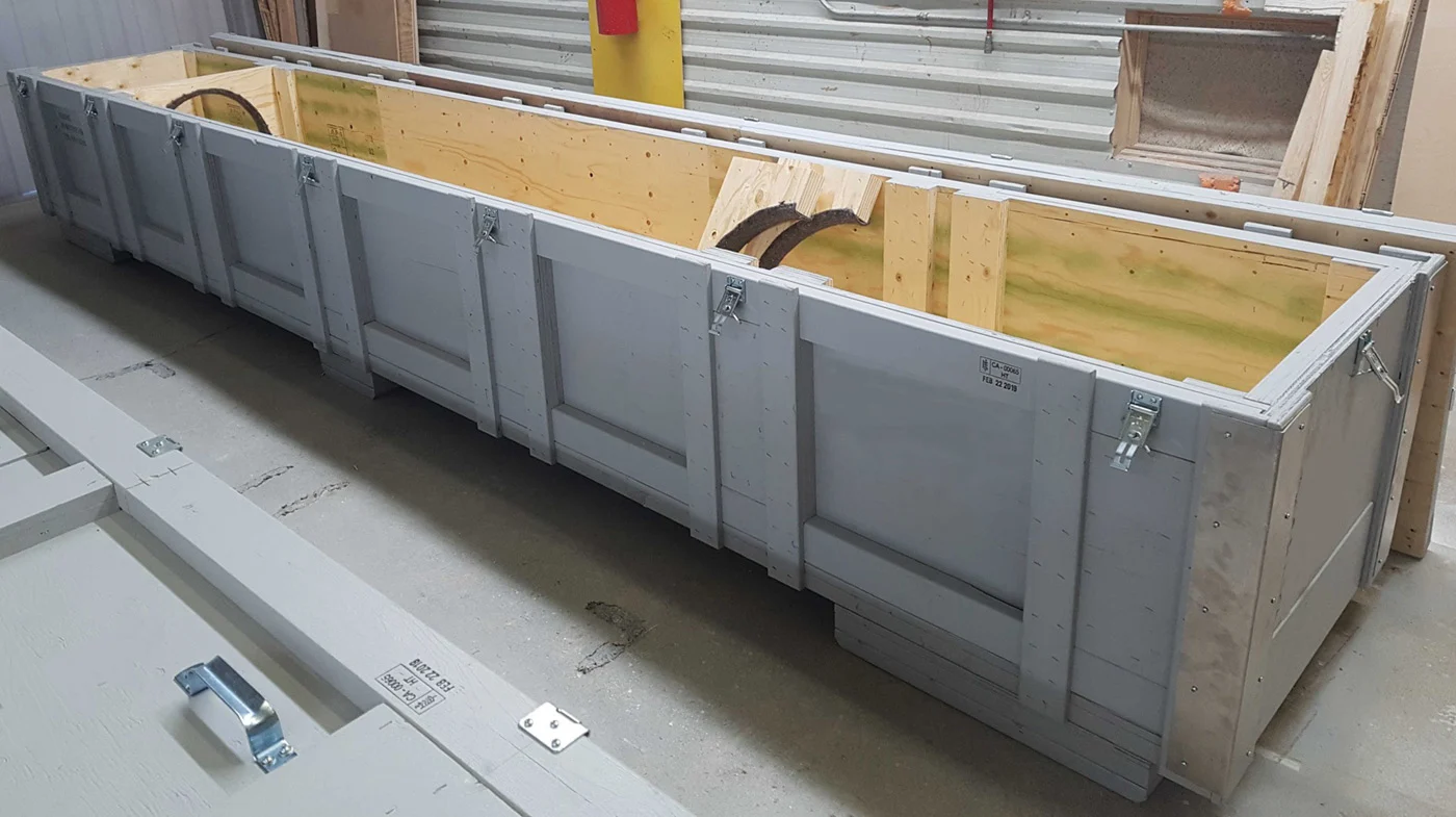 A long custom wood crate with latches on the sides. Manufactured by 204 Pallet & Packaging in Winnipeg, Manitoba.