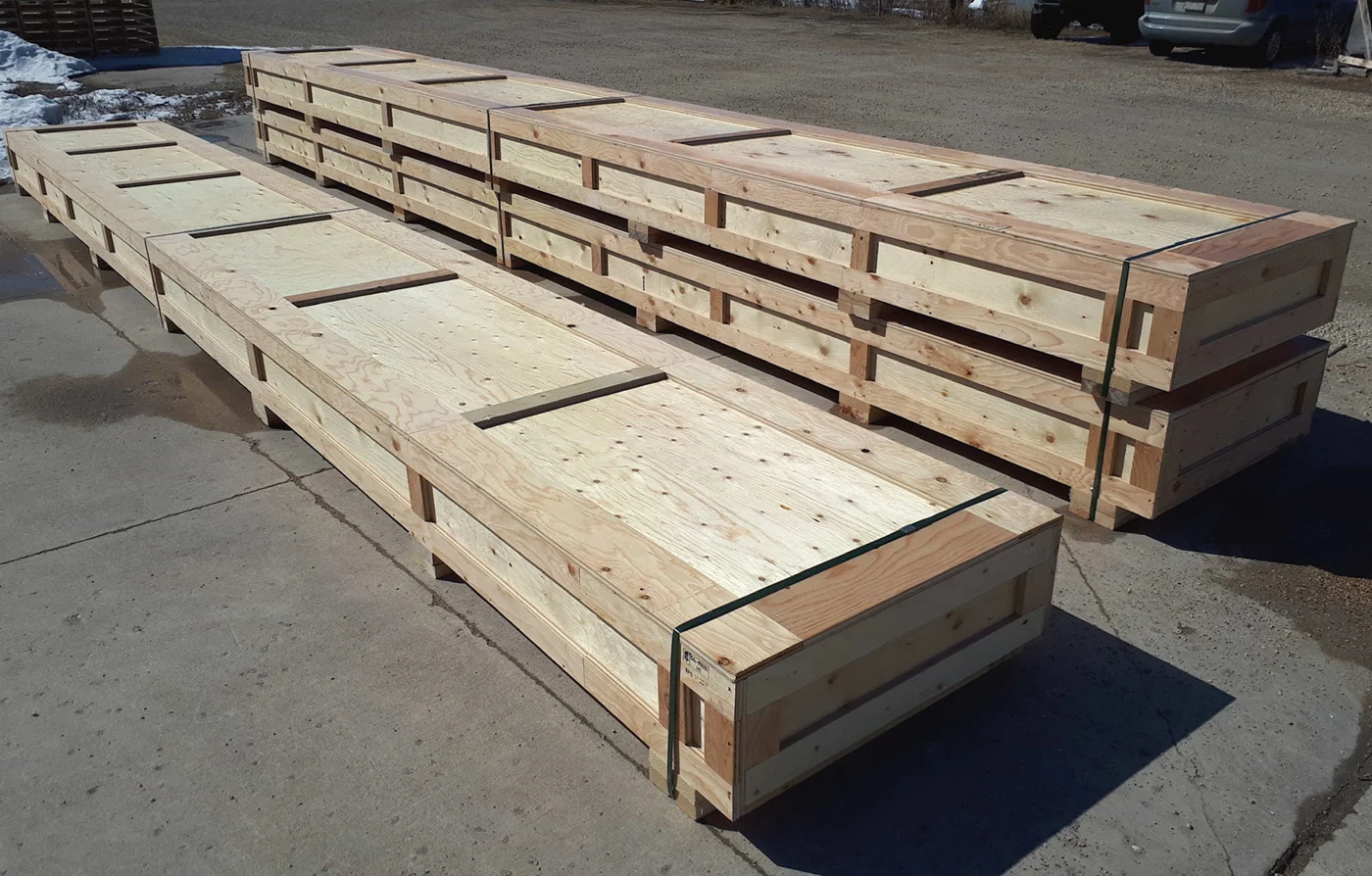 Long custom wooden crates built by 204 Pallet & Packaging in Manitoba for specialized shipping needs.